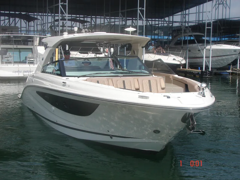 Slide: The Image of 2018 Sea Ray SLX 400 boat docked in marina, featuring sleek design and spacious seating. - 19