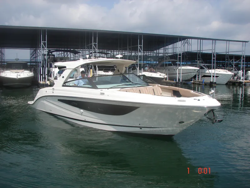 Slide: The Image of 2018 Sea Ray SLX 400 boat docked at marina under cloudy sky. - 20
