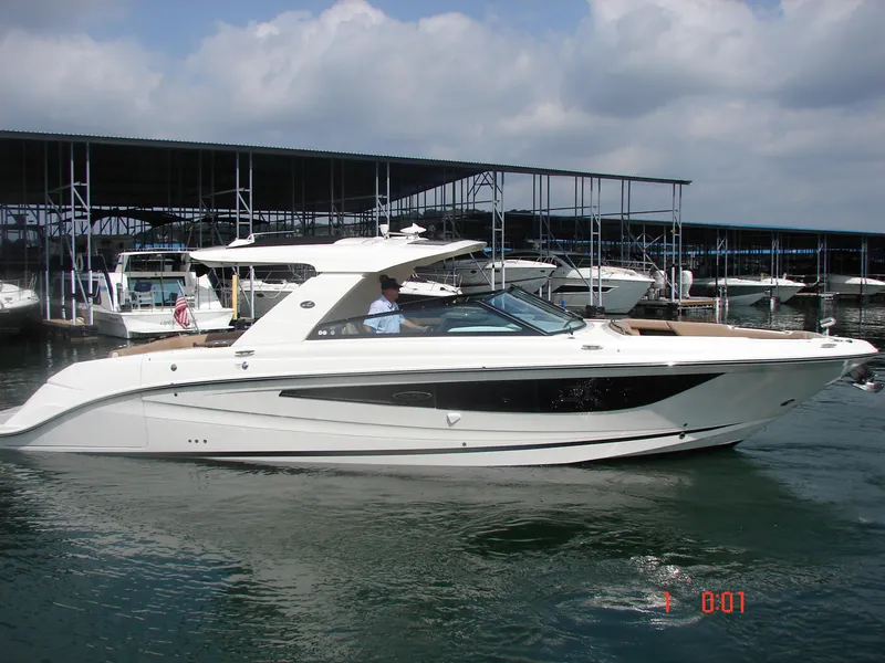 Slide: The Image of 2018 Sea Ray SLX 400 boat docked at marina under cloudy sky. - 23