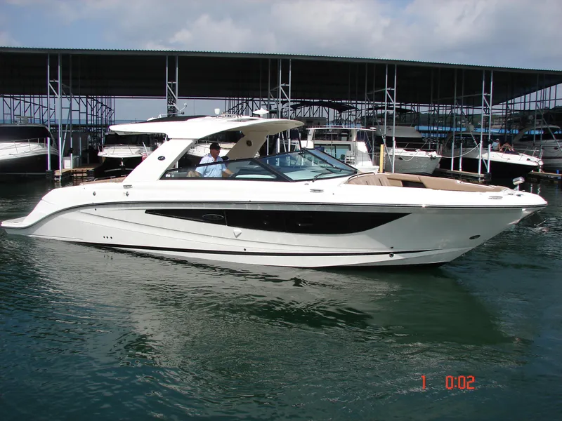 Slide: The Image of 2018 Sea Ray SLX 400 boat docked at marina, sleek design, calm water. - 24