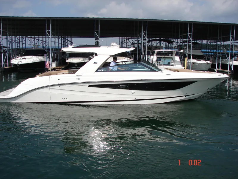 Slide: The Image of 2018 Sea Ray SLX 400 boat docked at marina, side view. - 27