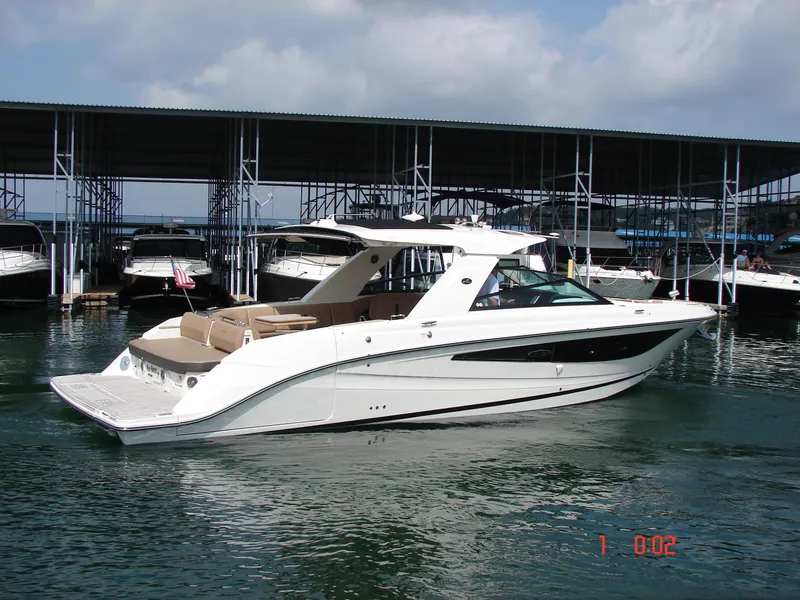 Slide: The Image of 2018 Sea Ray SLX 400 boat docked in marina, featuring sleek design and spacious deck. - 28