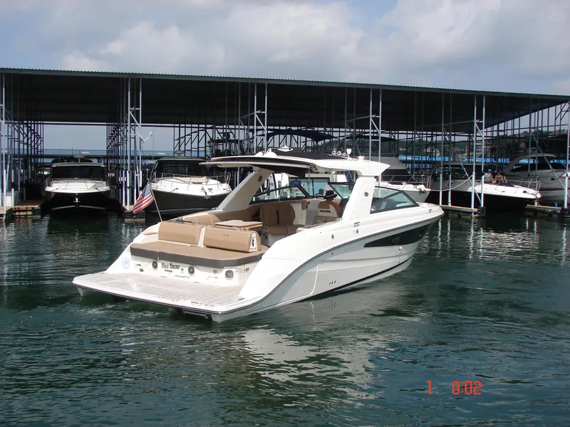 Slide: The Image of 2018 Sea Ray SLX 400 boat docked in marina, featuring sleek design and spacious deck. - 29
