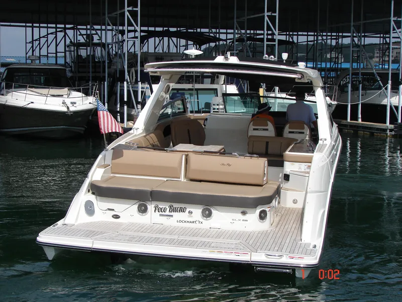 Slide: The Image of 2018 Sea Ray SLX 400 boat docked, featuring spacious seating and sleek design. - 30
