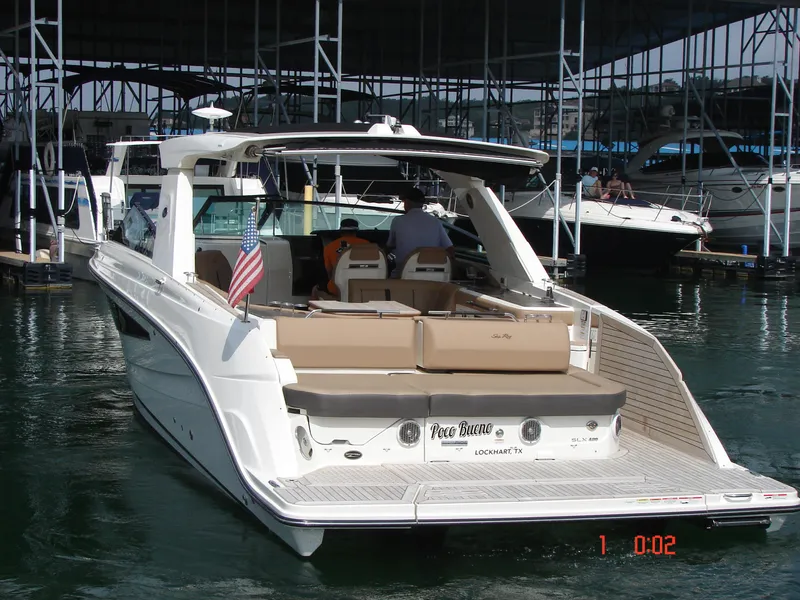 Slide: The Image of 2018 Sea Ray SLX 400 yacht docked, featuring spacious seating and sleek design. - 32