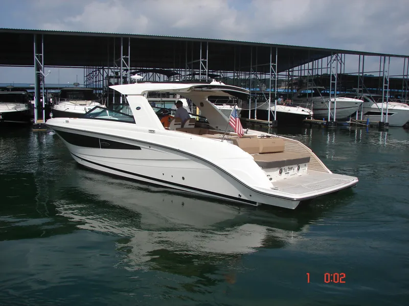 Slide: The Image of 2018 Sea Ray SLX 400 boat docked in marina, featuring sleek design and spacious deck. - 33