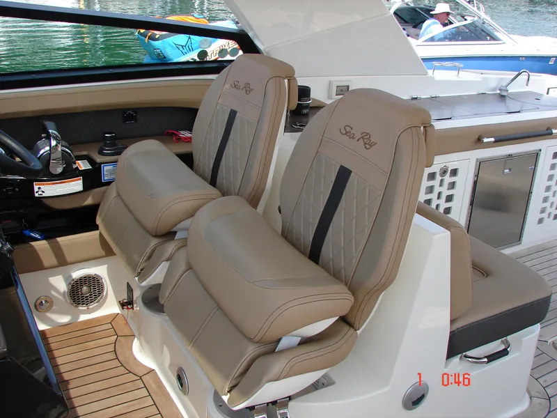 Slide: The Image of 2018 Sea Ray SLX 400 boat interior with luxurious tan seating and modern dashboard. - 42