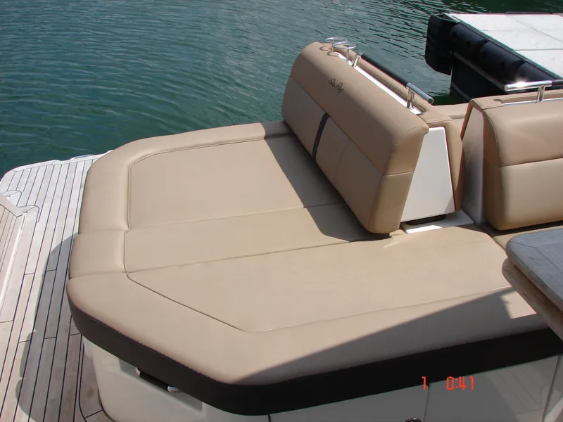 Slide: The Image of 2018 Sea Ray SLX 400 boat with beige seating, docked on calm water. - 43