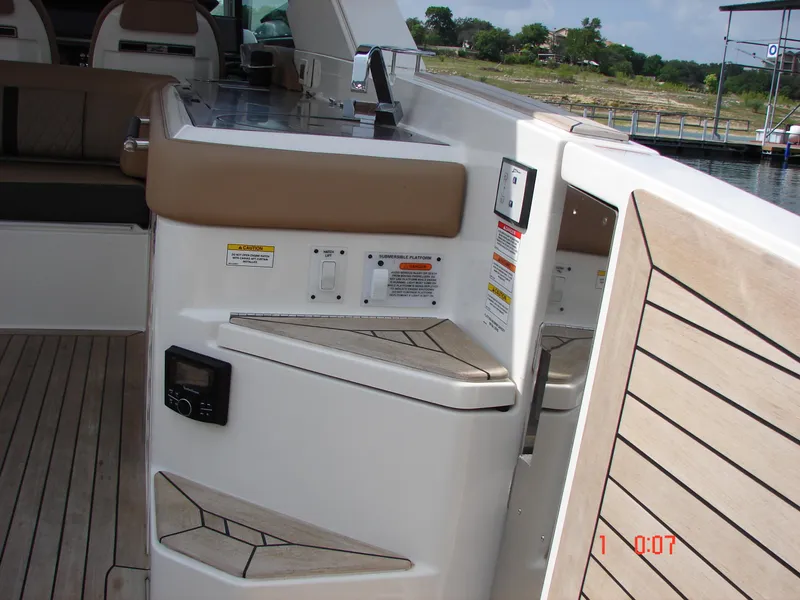 Slide: The Image of 2018 Sea Ray SLX 400 boat interior with wooden deck and control panel. - 7
