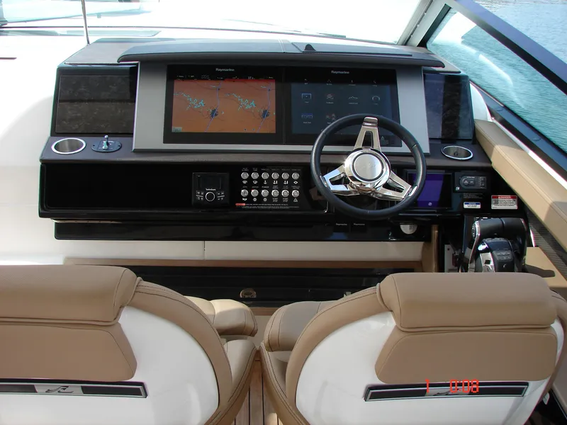 Slide: The Image of 2018 Sea Ray SLX 400 helm with dual screens and leather seats. - 9