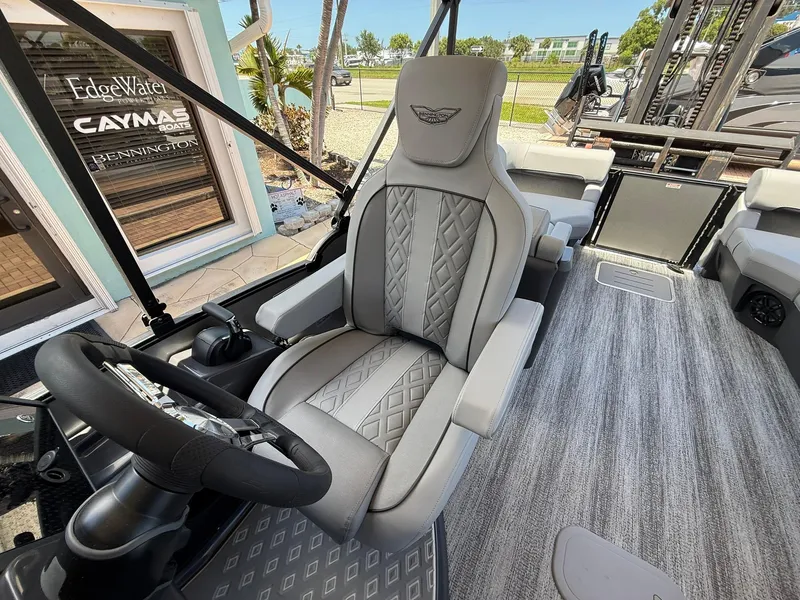 Slide: The Image of Luxurious interior of 2026 Bennington 26 MFB boat with plush seating and modern steering. - 13