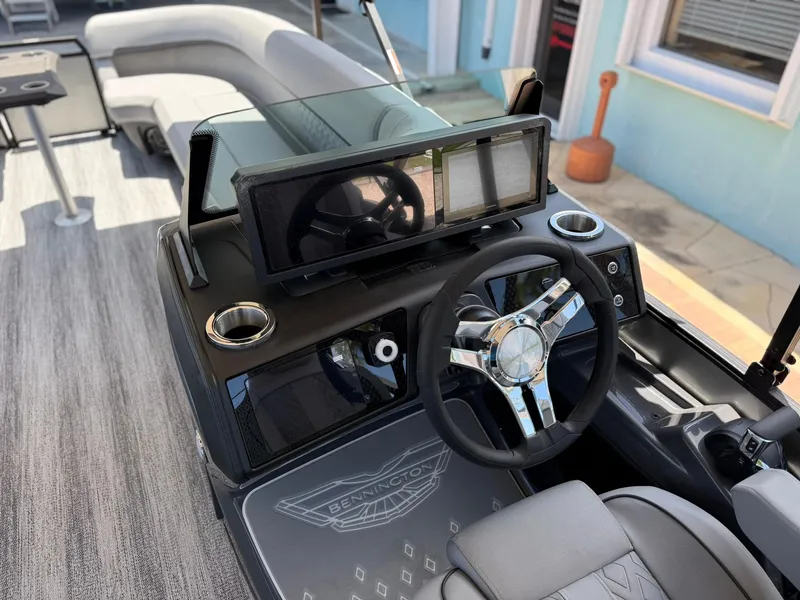 Slide: The Image of 2026 Bennington 26 MFB boat interior with modern steering and dashboard. - 14