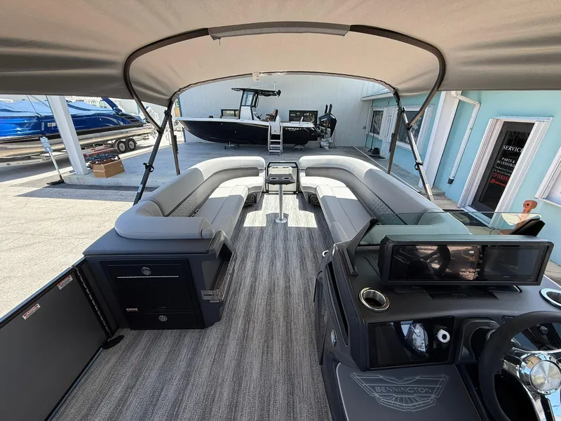 Slide: The Image of Interior of 2026 Bennington 26 MFB boat with spacious seating and modern dashboard. - 15