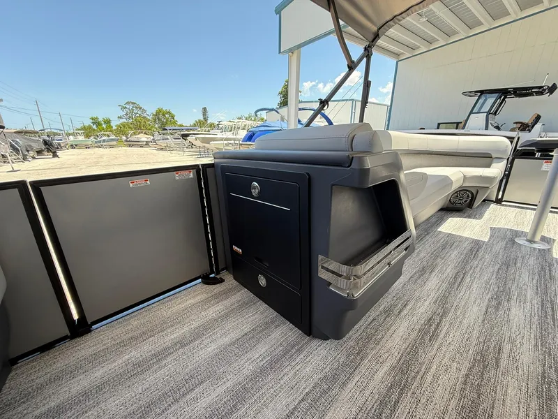 Slide: The Image of 2026 Bennington 26 MFB boat interior with modern seating and storage, showcasing luxury design. - 16