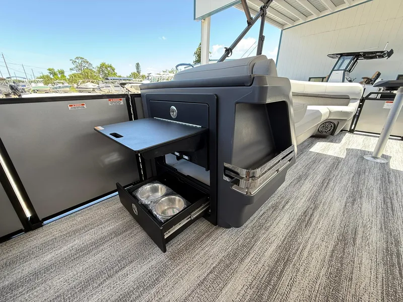 Slide: The Image of Bennington 26 MFB 2026 boat interior with pull-out table and storage drawers. - 18