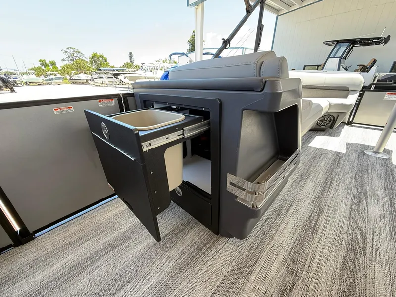 Slide: The Image of 2026 Bennington 26 MFB boat with open storage compartment on deck. - 19