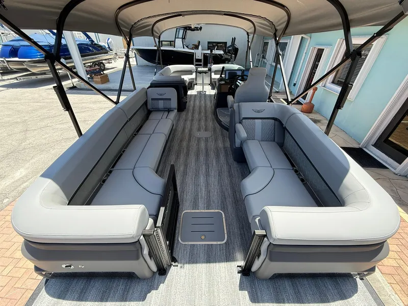 Slide: The Image of 2026 Bennington 26 MFB pontoon boat with spacious seating and canopy, docked at marina. - 4