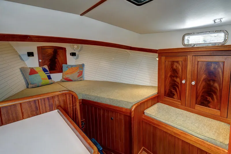Slide: The Image of Cozy cabin interior of 2008 Holland Open boat with wooden finish and colorful cushions. - 21