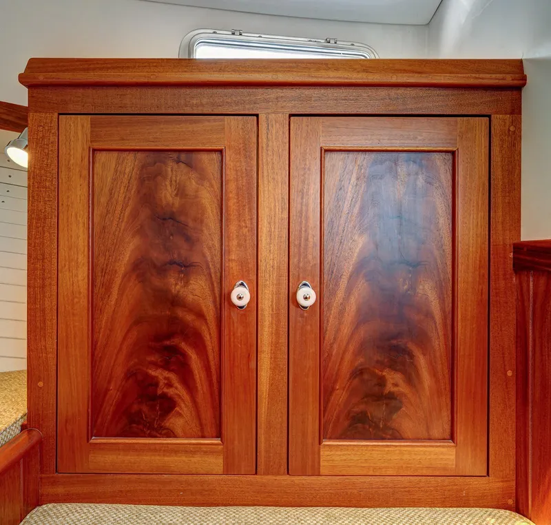 Slide: The Image of Wooden cabinet with rich grain pattern, featuring two doors and round handles, in a 2008 Holland Open. - 22