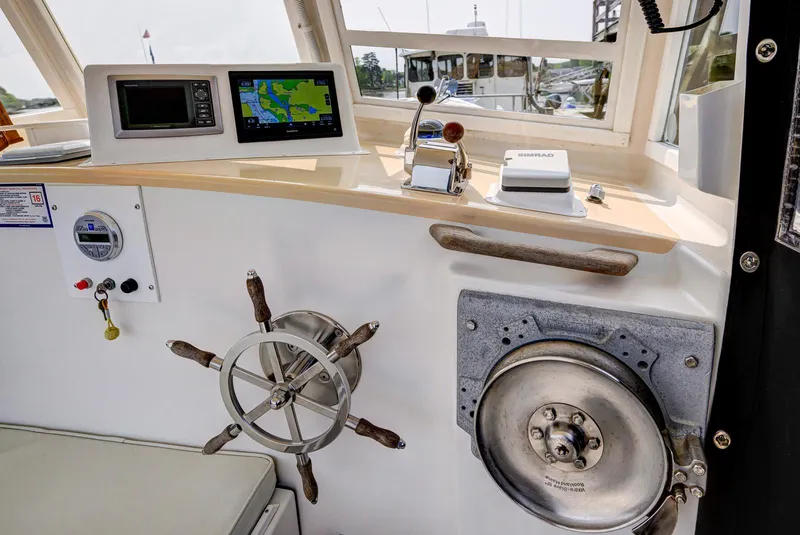 Slide: The Image of Control panel of a 2008 Holland Open boat with navigation equipment and steering wheel. - 28