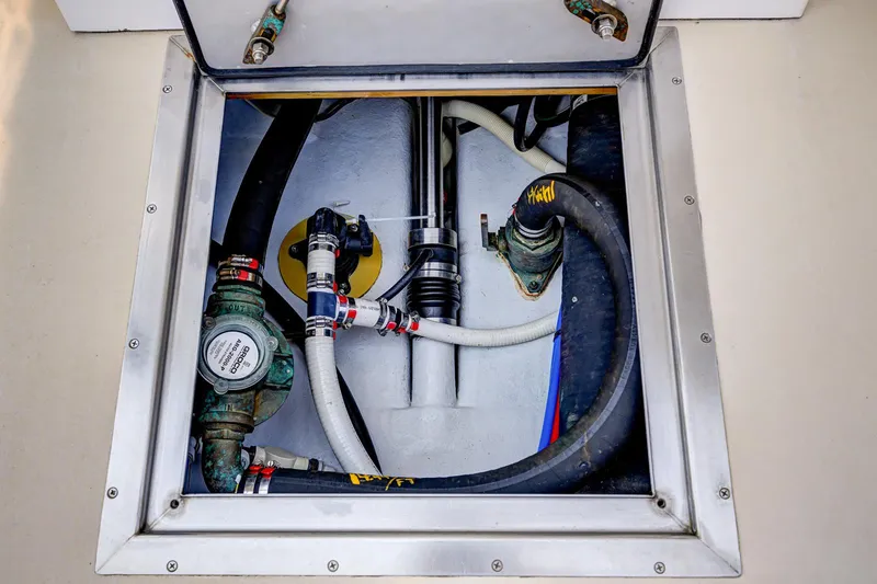 Slide: The Image of Engine compartment of a 2008 Holland Open boat, showing hoses and mechanical components. - 32