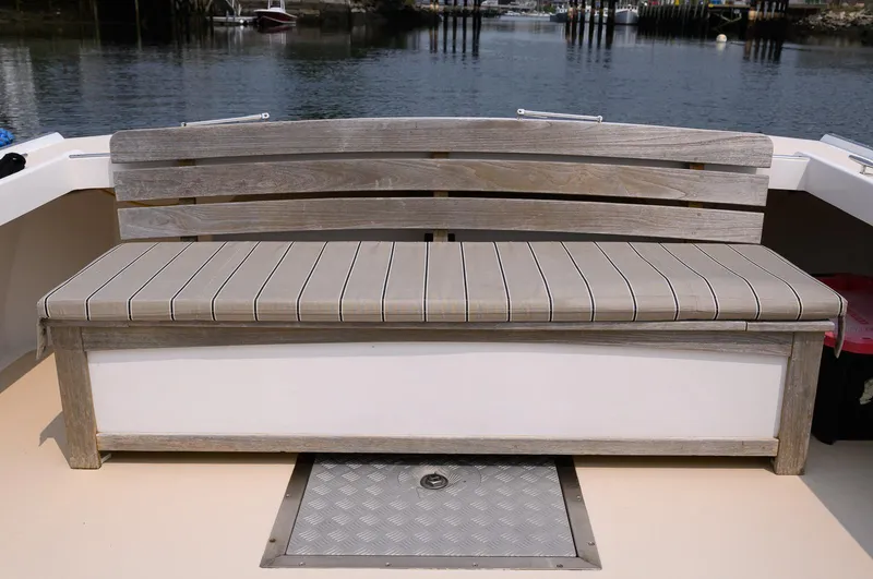 Slide: The Image of Wooden bench on a 2008 Holland Open boat, docked by the water. - 33