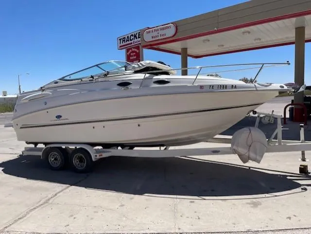 The Image of 2005 Chaparral Signature 260 boat on trailer at gas station. - 1
