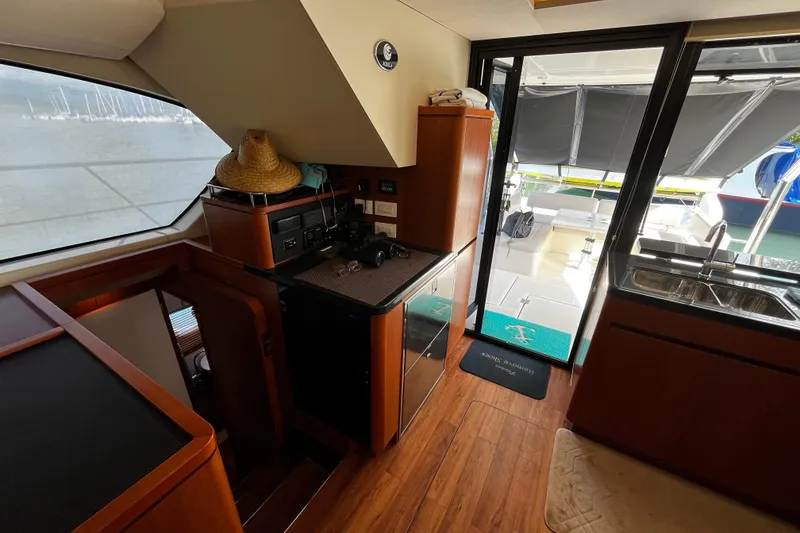 Slide: The Image of Interior of 2016 Aquila 44 yacht with wooden flooring and outdoor view. - 23