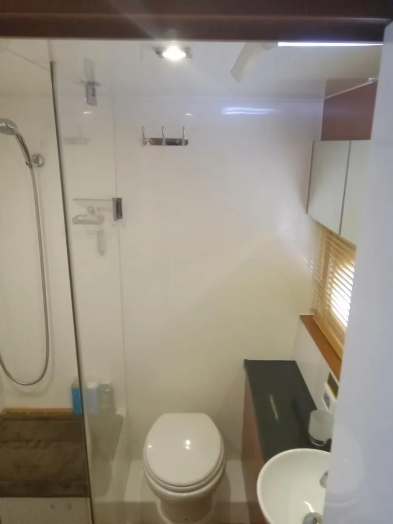 Slide: The Image of Modern bathroom in 2016 Aquila 44 yacht with shower, toilet, and sink. - 28
