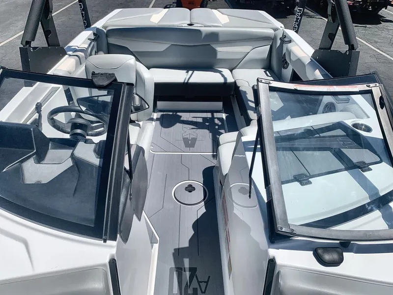 Slide: The Image of 2022 Axis A20 boat interior with seating and steering wheel, featuring sleek design and open layout. - 12