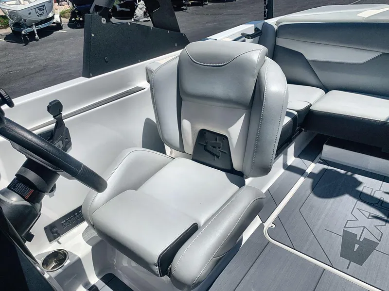 Slide: The Image of 2022 Axis A20 boat interior with gray seating and steering wheel. - 13