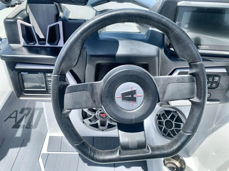 Slide: The Image of Steering wheel of a 2022 Axis A20 boat with modern dashboard features. - 14