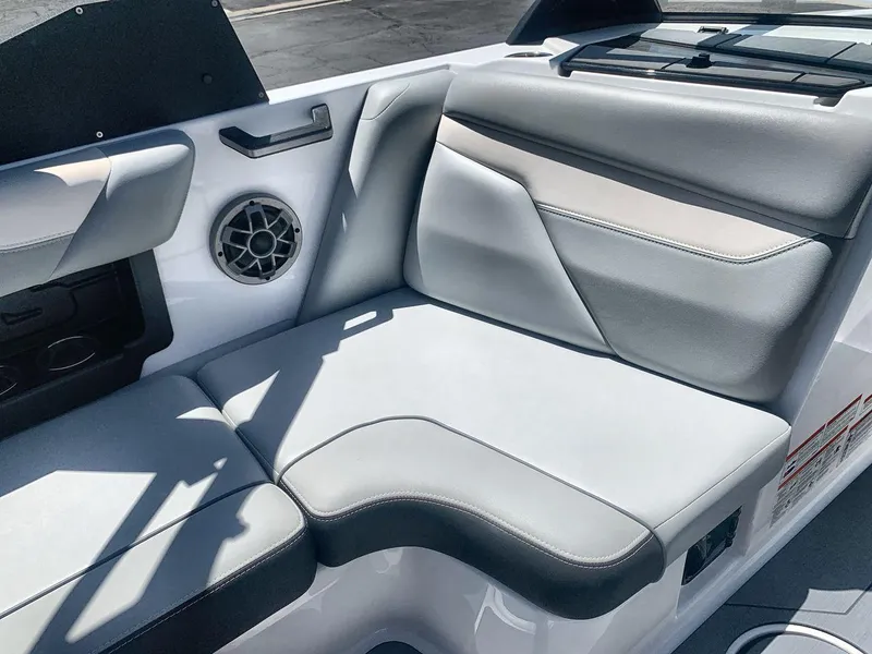 Slide: The Image of 2022 Axis A20 boat interior with gray seating and speaker detail. - 17