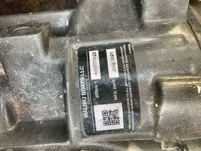 Slide: The Image of Label on Malibu Boats LLC engine part, showing serial and manufacturing date. - 24