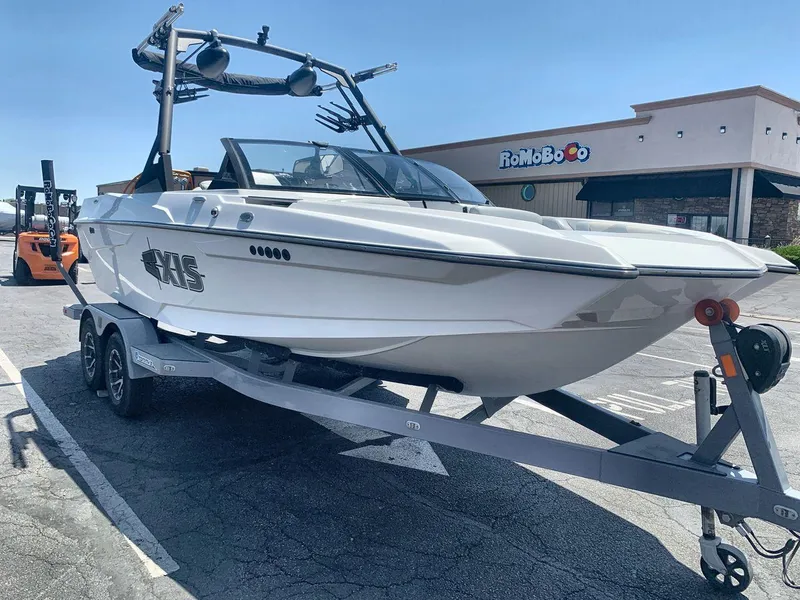 Slide: The Image of 2022 Axis A20 boat on trailer in parking lot, sunny day. - 7