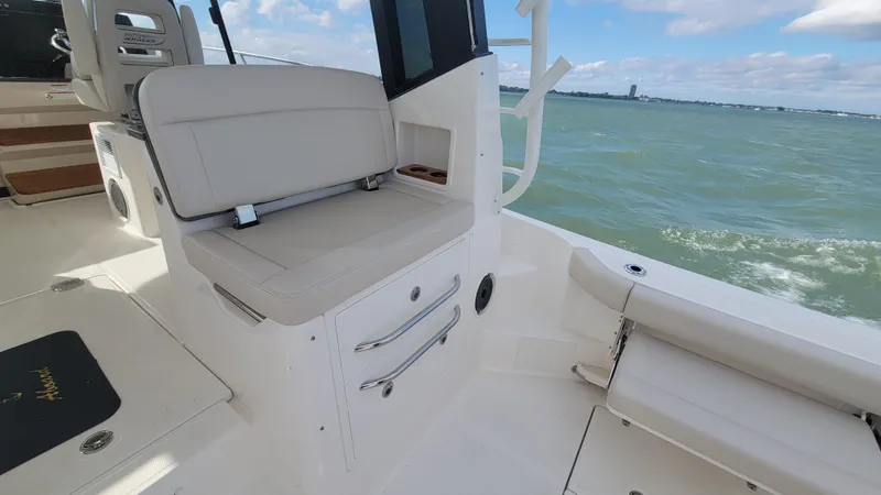 Slide: The Image of 2021 Boston Whaler 405 Conquest interior with seating, ocean view, and clear skies. - 10