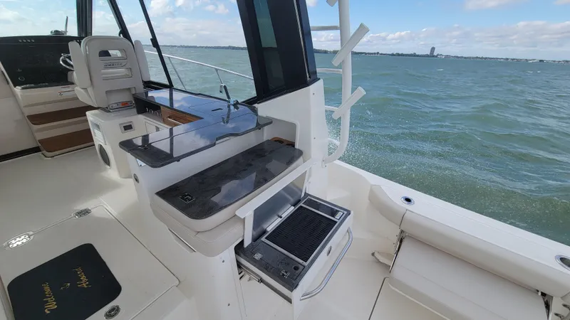 Slide: The Image of 2021 Boston Whaler 405 Conquest boat interior with ocean view and fishing station. - 11