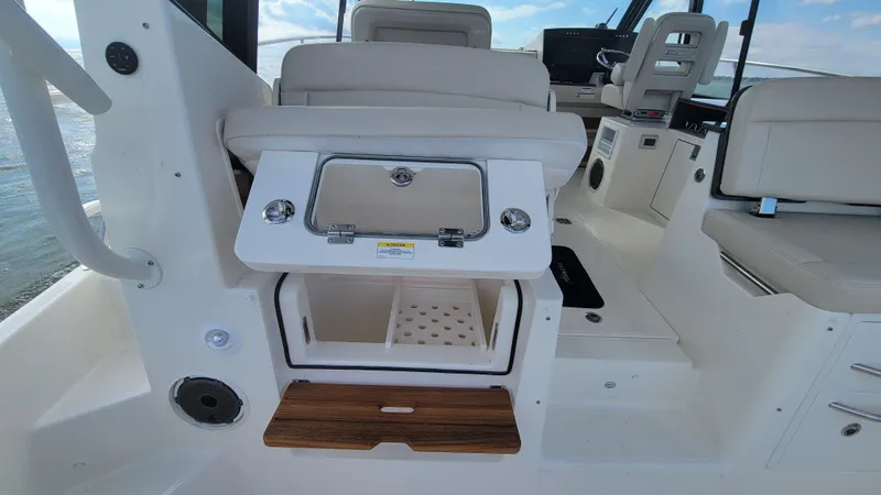 Slide: The Image of 2021 Boston Whaler 405 Conquest interior with seating and storage compartments. - 13