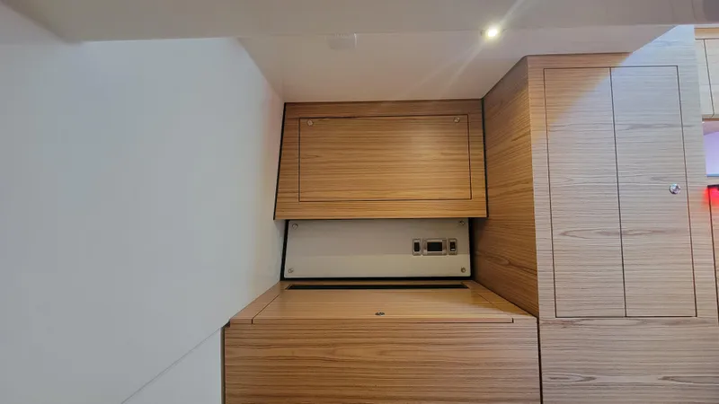 Slide: The Image of Interior of 2021 Boston Whaler 405 Conquest with wooden cabinetry and built-in appliance. - 20