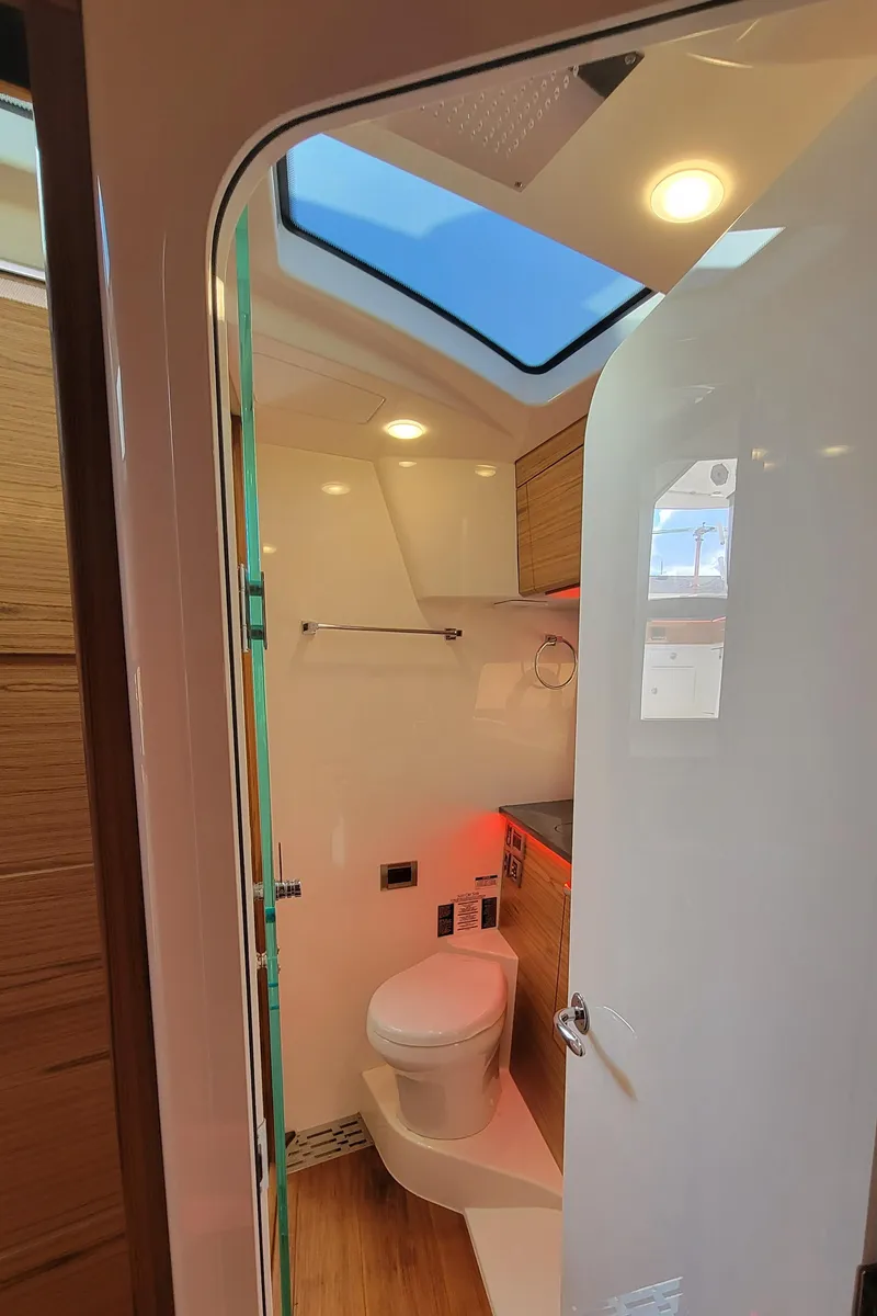 Slide: The Image of Interior view of 2021 Boston Whaler 405 Conquest bathroom with modern fixtures and skylight. - 21