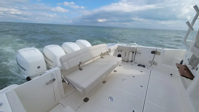 Slide: The Image of 2021 Boston Whaler 405 Conquest boat with multiple engines on open water. - 23