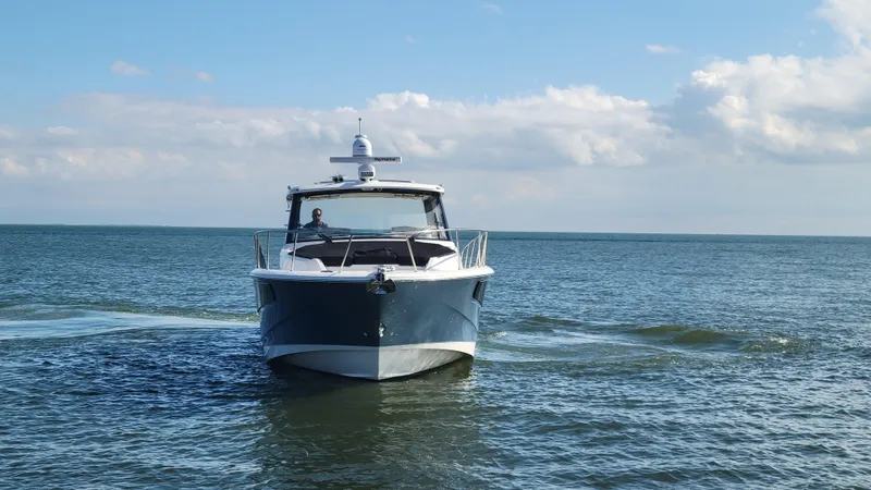 Slide: The Image of Boston Whaler 405 Conquest 2021 cruising on open water under a clear sky. - 3