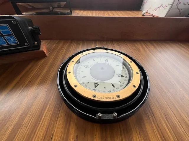 Slide: The Image of Compass on 1989 Maritime 340 Trawler's wooden dashboard, showcasing nautical navigation equipment. - 11