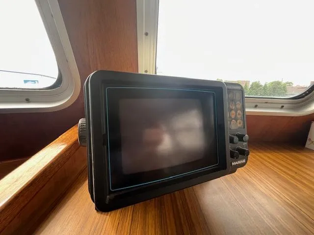 Slide: The Image of 1989 Maritime 340 Trawler interior with vintage navigation equipment on wooden dashboard. - 13