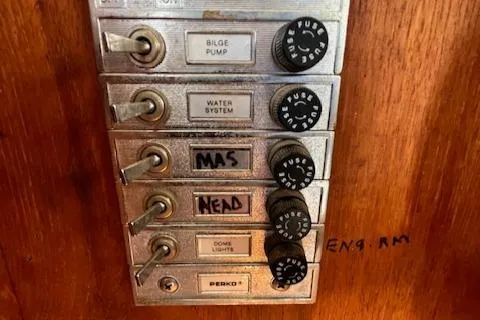 Slide: The Image of Control panel of a 1989 Maritime 340 Trawler with labeled switches and fuses. - 16