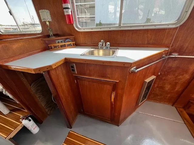 Slide: The Image of 1989 Maritime 340 Trawler kitchen with wooden cabinetry and stainless steel sink. - 17