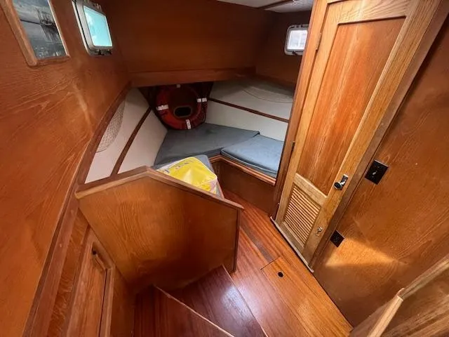 Slide: The Image of 1989 Maritime 340 Trawler cabin interior with wooden finish and cozy sleeping area. - 18