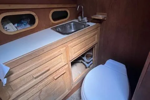 Slide: The Image of 1989 Maritime 340 Trawler bathroom with wooden cabinetry, sink, and toilet. - 20