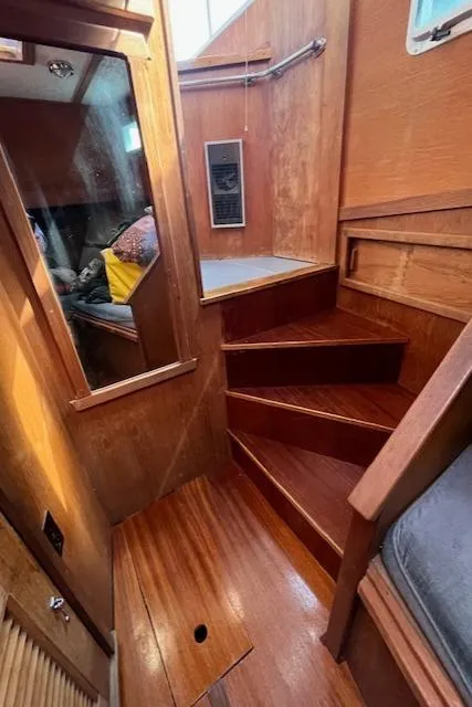 Slide: The Image of Interior of 1989 Maritime 340 Trawler with wooden stairs and cozy cabin space. - 21