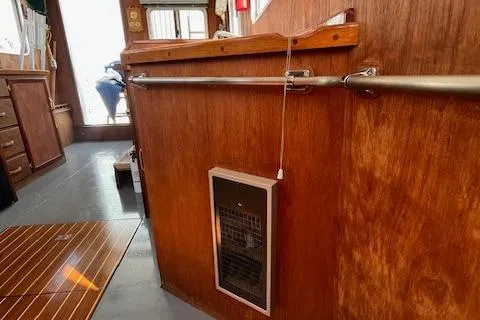 Slide: The Image of 1989 Maritime 340 Trawler interior with wooden paneling and built-in heater. - 22